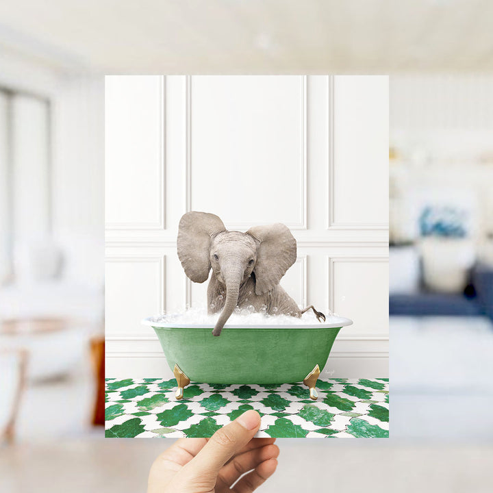 A small elephant sitting in a green bathtub filled with water, surrounded by a patterned floor.