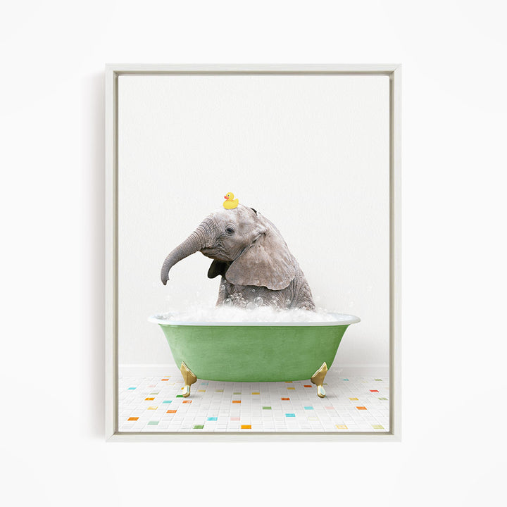 A gray elephant is sitting in a green bathtub, with a yellow rubber duck perched on its head.
