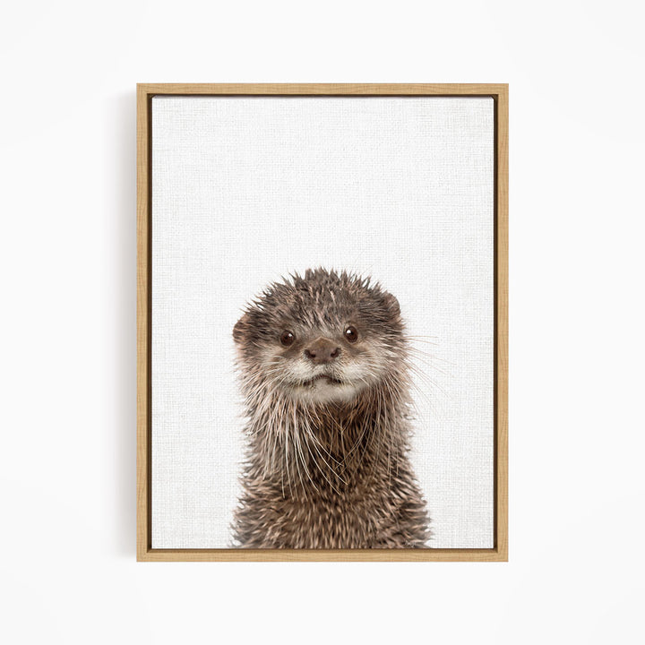A close-up portrait of an otter with a curious expression, looking directly at the camera.