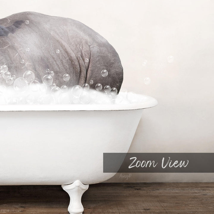 A gray elephant is sitting in a white bathtub filled with bubbles, creating a whimsical and playful scene.