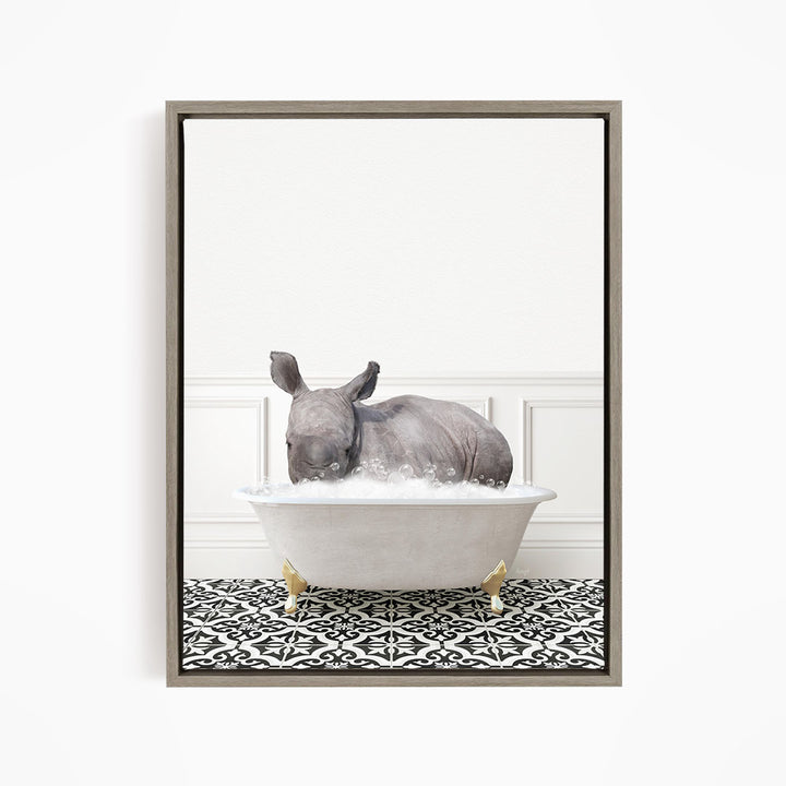 A rhinoceros is sitting in a bathtub filled with water, creating a whimsical and playful scene.