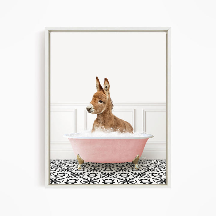 A donkey is sitting in a pink bathtub filled with bubbles, surrounded by a black and white patterned floor.