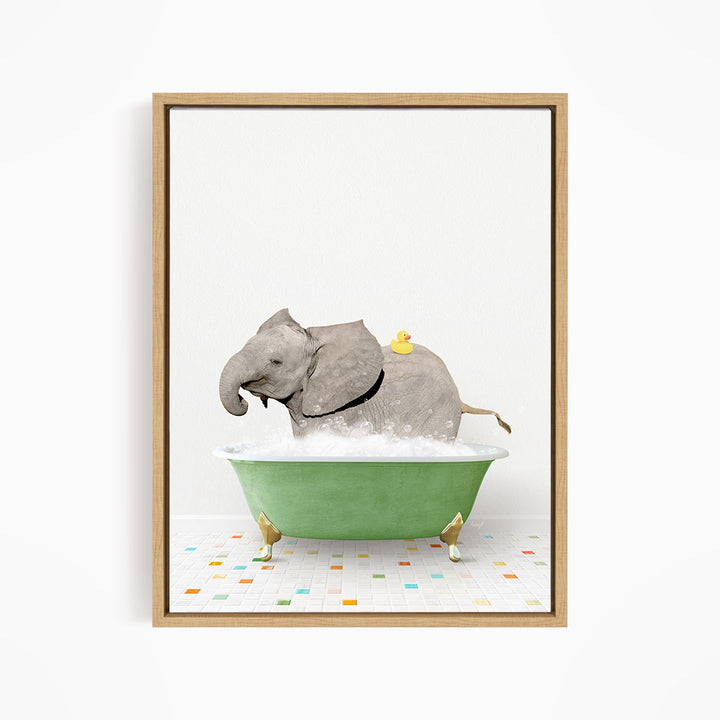 A gray elephant is sitting in a green bathtub filled with water, with a yellow rubber duck floating on its back.