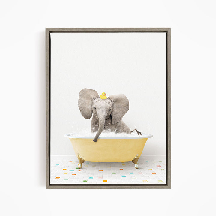 A gray elephant is sitting in a yellow bathtub filled with water, with a rubber duck floating on its head.