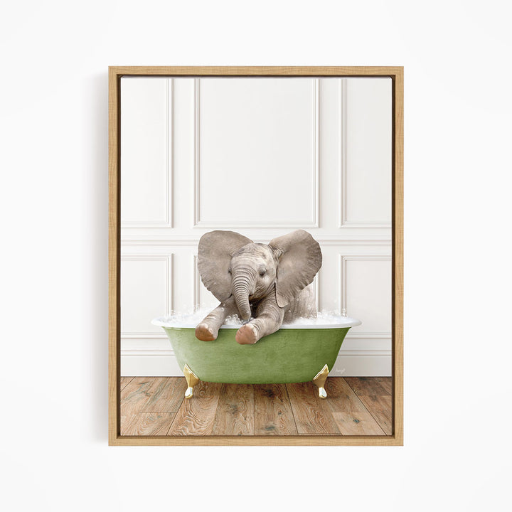 A baby elephant sitting in a green bathtub filled with water, with its trunk raised and ears spread out.