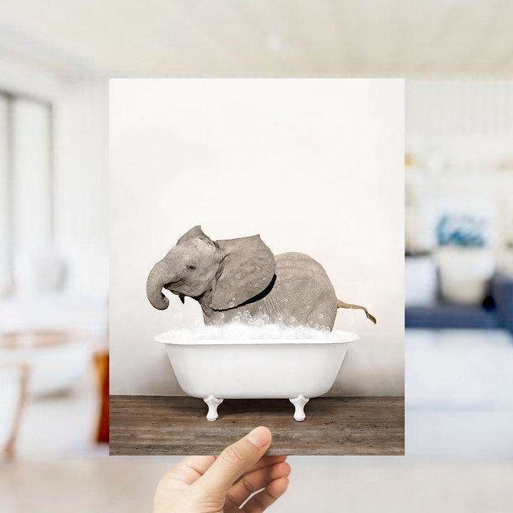 A gray elephant is sitting in a white bathtub filled with water, creating a whimsical and playful scene.