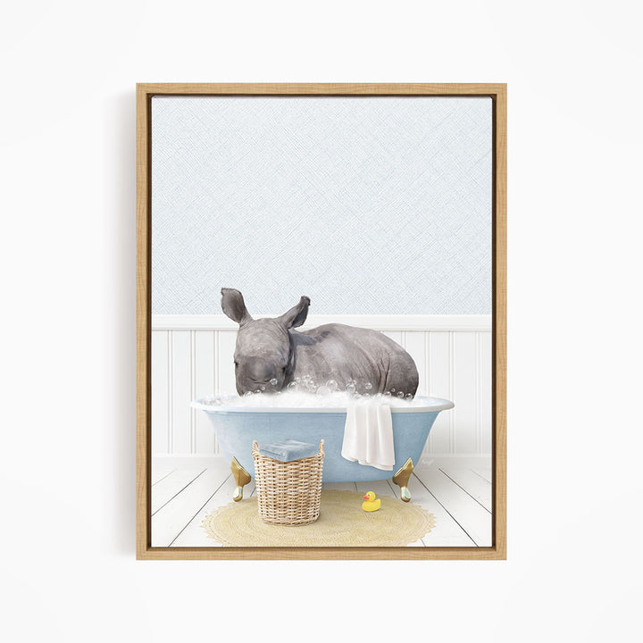 A rhinoceros is sitting in a blue bathtub filled with water, surrounded by rubber ducks.