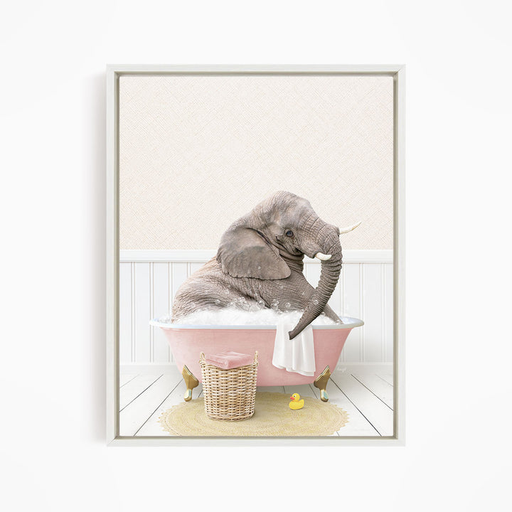 A gray elephant is sitting in a pink bathtub filled with water, surrounded by a yellow rubber duck and a basket.