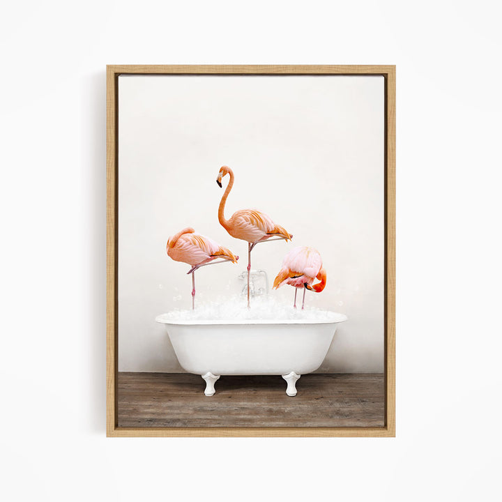 A framed image depicting three flamingos standing in a white bathtub filled with water.