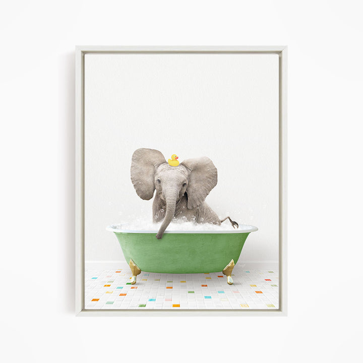 A gray elephant is sitting in a green bathtub filled with water, with a yellow rubber duck floating on its head.