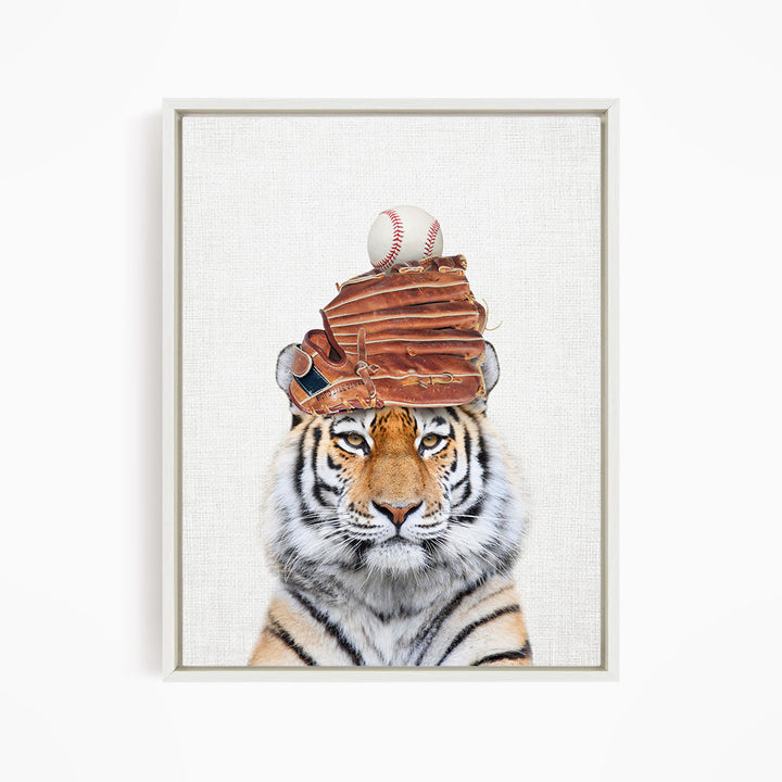 A tiger wearing a baseball cap and holding a baseball in its mouth.
