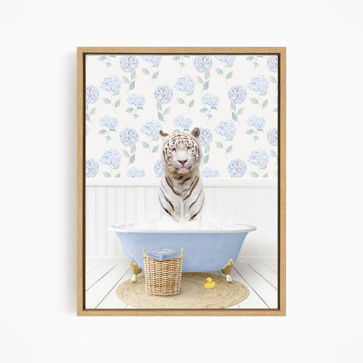 A white tiger is sitting in a blue bathtub filled with water, surrounded by a wicker basket and rubber ducks.