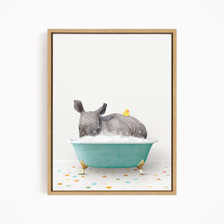 A rhinoceros is sitting in a blue bathtub filled with bubbles, with a yellow rubber duck floating on its back.