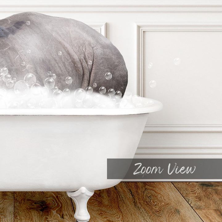 A large gray elephant is sitting in a white bathtub filled with bubbles, creating a whimsical and playful scene.