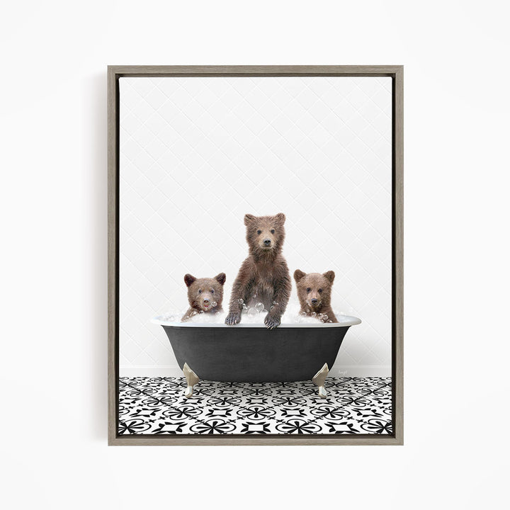 A framed image depicting three brown bears sitting in a bathtub filled with water, with a black and white patterned floor beneath them.