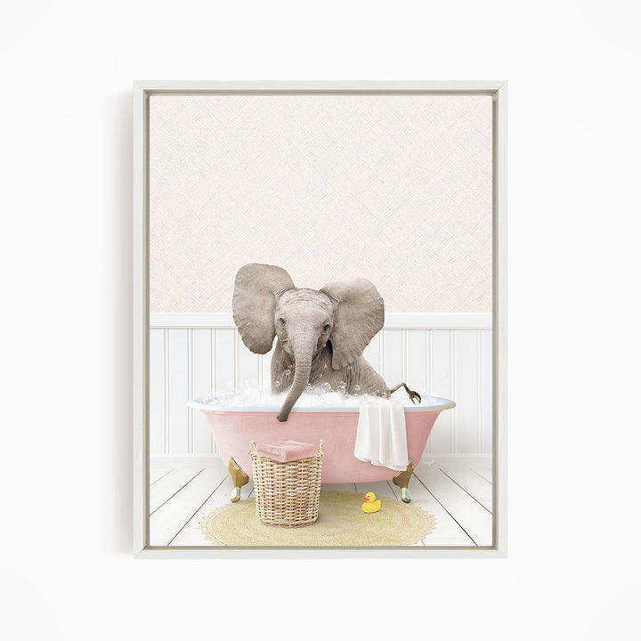 A gray elephant is sitting in a pink bathtub filled with water, surrounded by a yellow rubber duck and a basket.