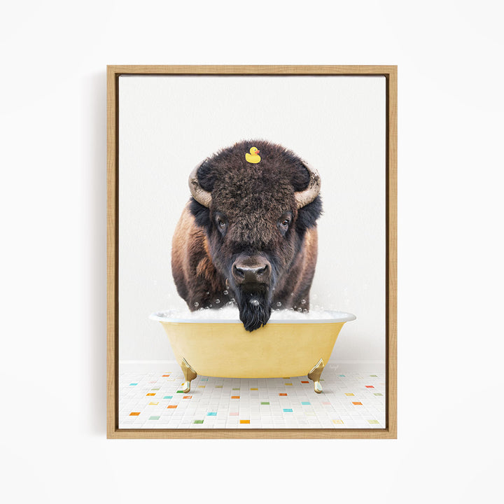 A buffalo with a yellow rubber duck sitting in a yellow bathtub.