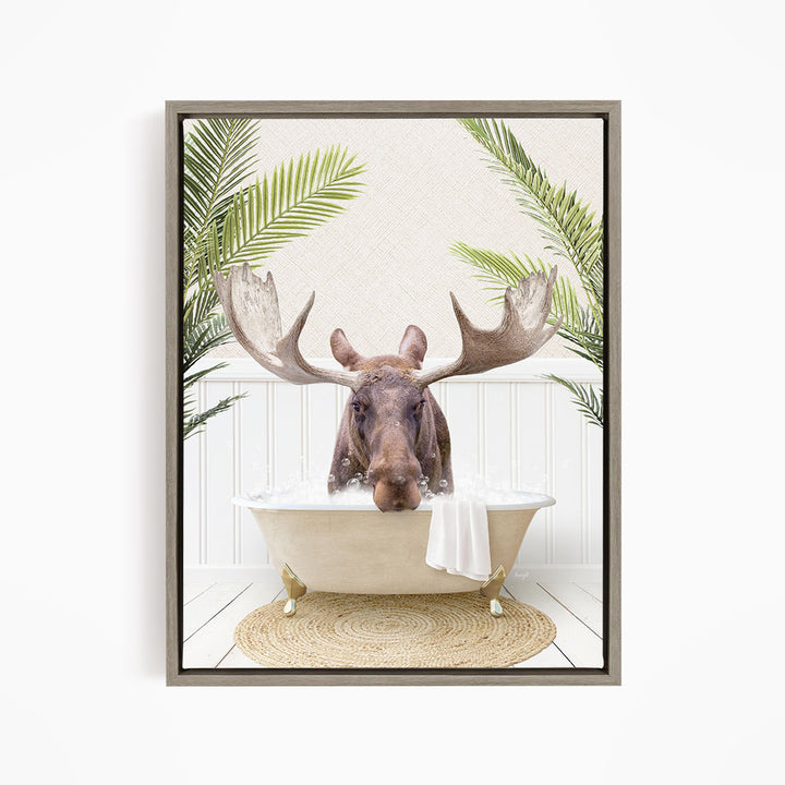 A moose with large antlers is sitting in a bathtub filled with water, surrounded by green palm leaves.