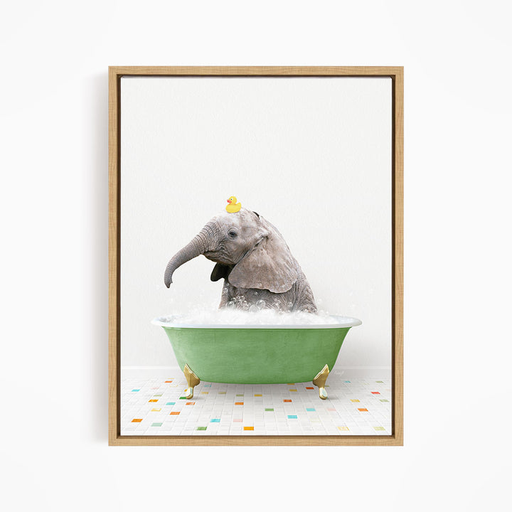 A gray elephant is sitting in a green bathtub, with a yellow rubber duck perched on its head.