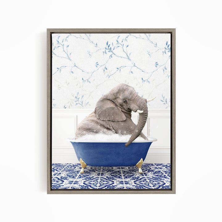 A gray elephant is sitting in a blue bathtub, surrounded by a blue and white patterned rug on the floor.