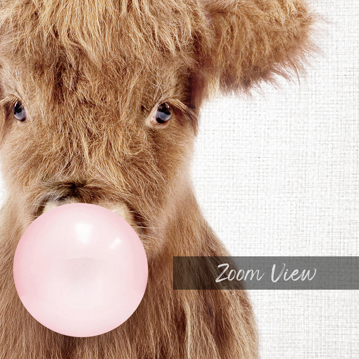 A close-up of a brown cow blowing a pink bubble with its mouth, as if it's blowing a bubble gum bubble.