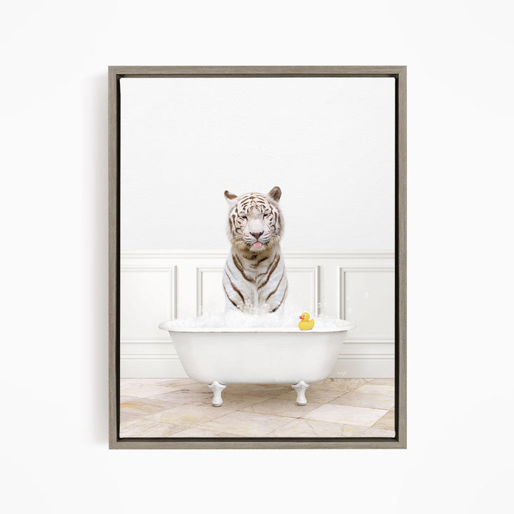 A white tiger sits in a white bathtub filled with water, with a rubber duck floating nearby.