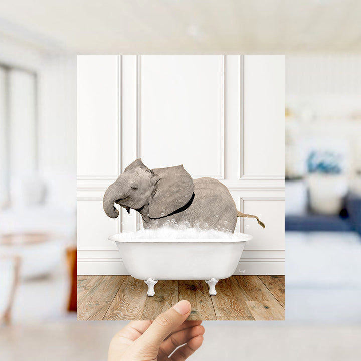 A gray elephant is sitting in a white bathtub filled with water, creating a whimsical and playful scene.