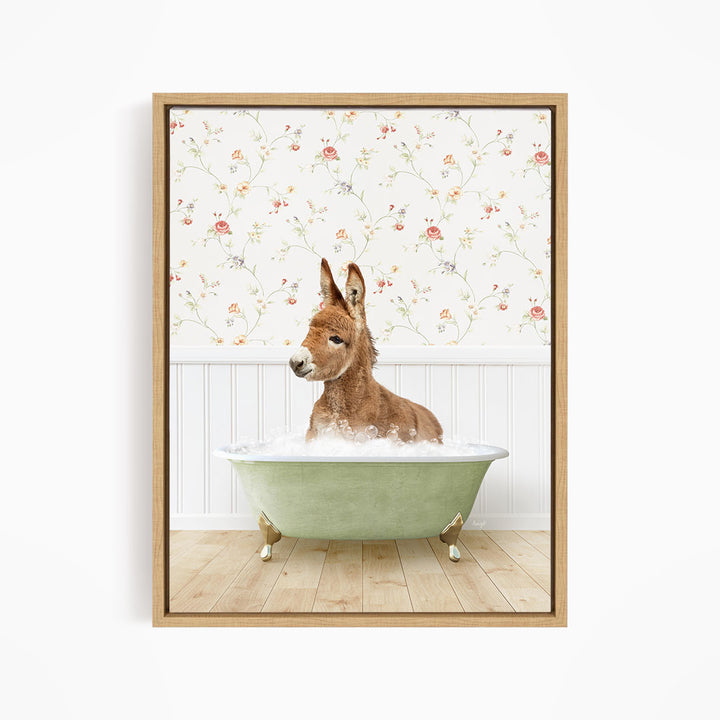 A donkey is sitting in a green bathtub filled with water, surrounded by a floral wallpaper.