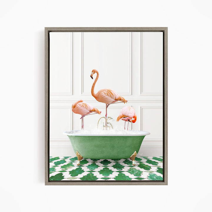 A framed image depicting three pink flamingos standing in a green bathtub filled with water, with a green and white patterned floor beneath.