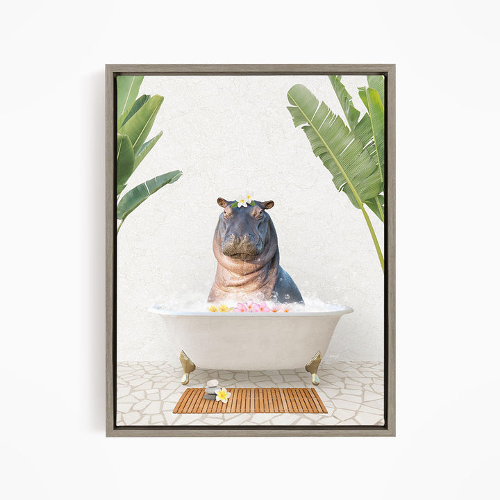 A framed image depicting a hippopotamus sitting in a bathtub filled with bubbles, surrounded by tropical plants and a wooden mat.