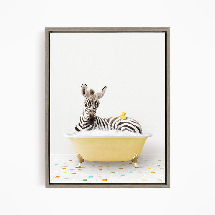 A zebra is sitting in a yellow bathtub, with a rubber duck resting on its back.
