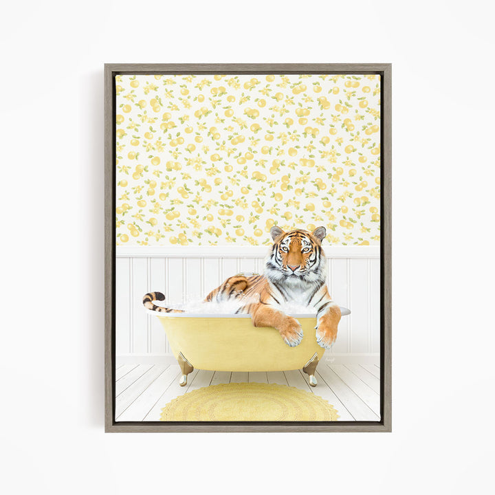 A tiger is sitting in a yellow bathtub, surrounded by a yellow and white floral patterned wallpaper.