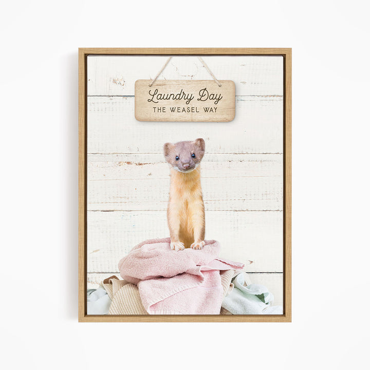 A weasel standing on a pile of clothes, with a wooden sign above that says "Laundry Day The Weasel Way".
