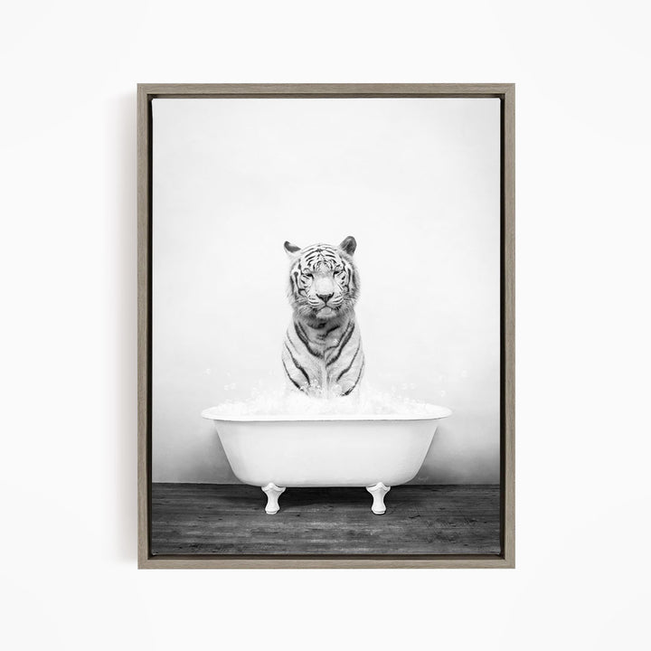 A black and white photograph of a tiger sitting in a bathtub filled with water.