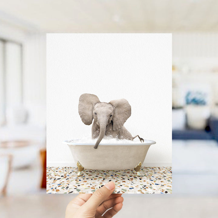 A small elephant sitting in a bathtub filled with water, with its trunk submerged in the water.
