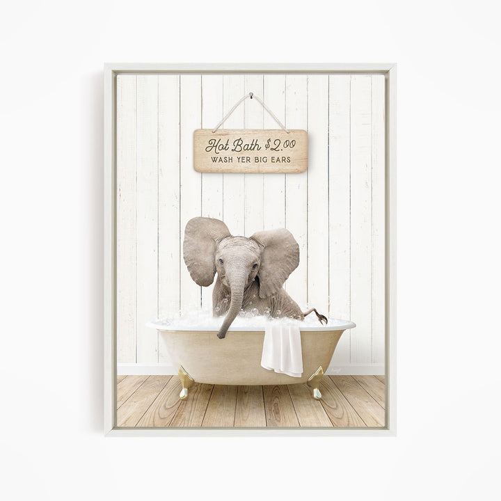 A framed image of an elephant sitting in a bathtub, with a sign above it that reads "Hot Bath $2.00 WASH YER BIG EARS".