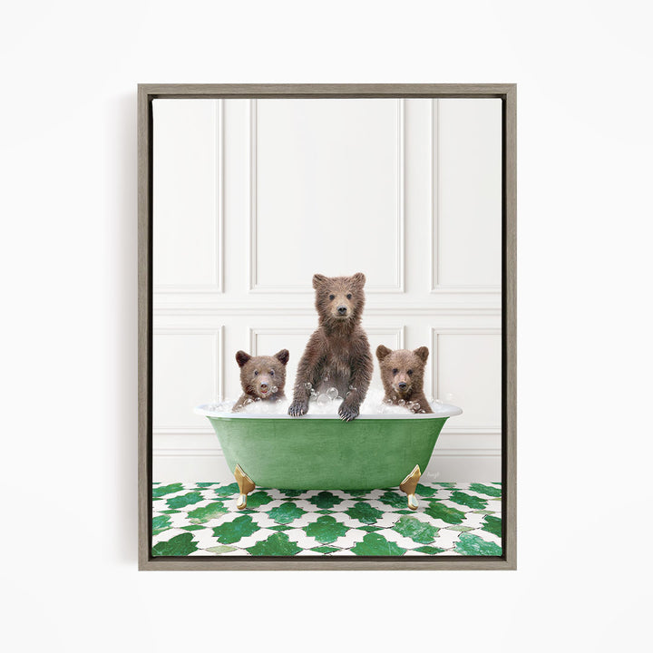 A framed image depicting three bears sitting in a green bathtub filled with water, with a patterned green and white floor beneath them.