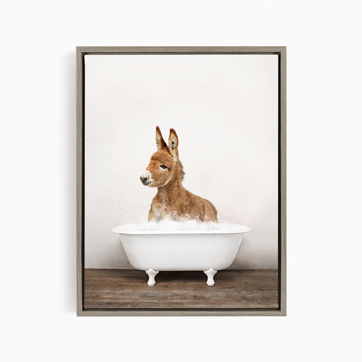 A donkey is sitting in a white bathtub filled with bubbles, creating a playful and whimsical scene.