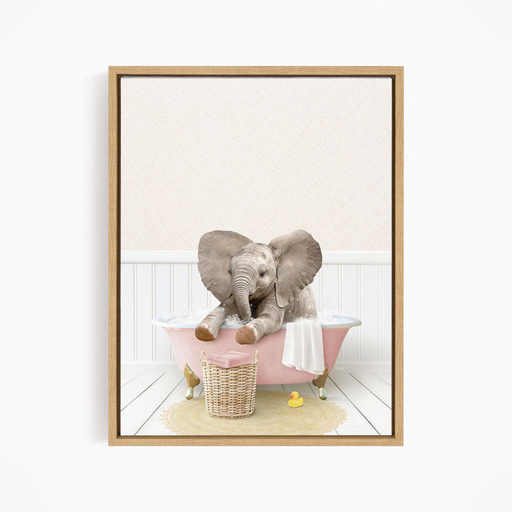 A baby elephant sitting in a pink bathtub, surrounded by a basket of toys and a yellow rubber ducky.