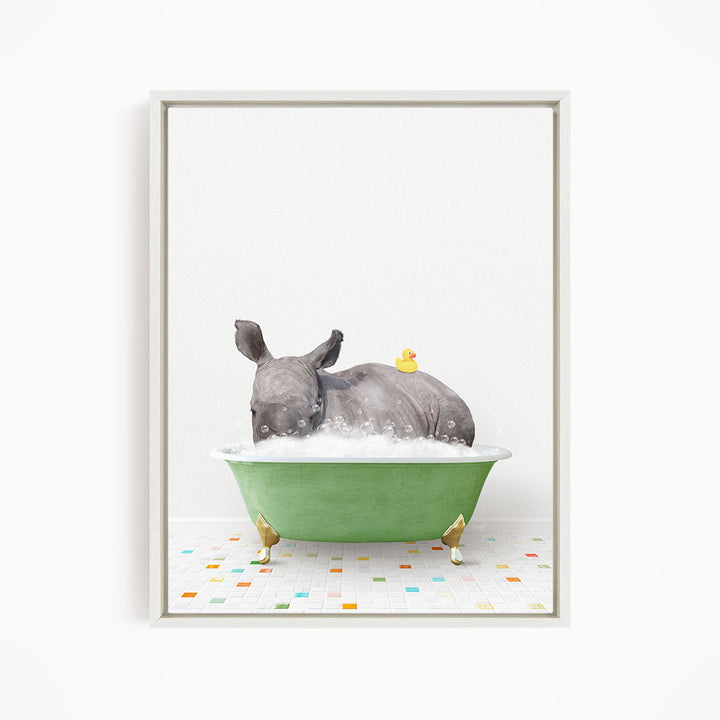 A rhinoceros is sitting in a green bathtub filled with bubbles, with a yellow rubber duck floating on its back.