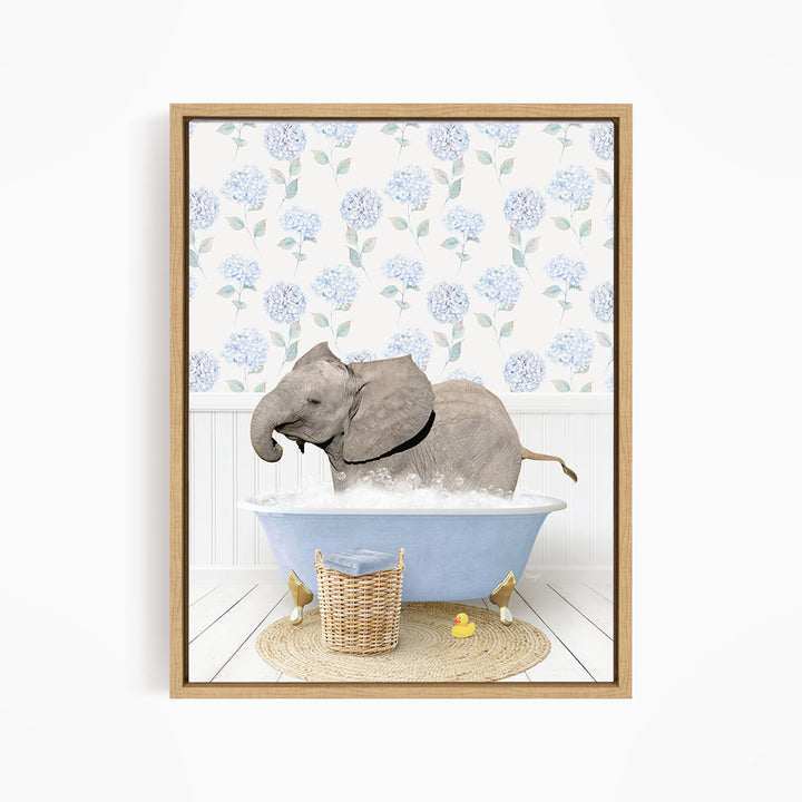 A gray elephant is sitting in a blue bathtub filled with water, surrounded by yellow rubber ducks.