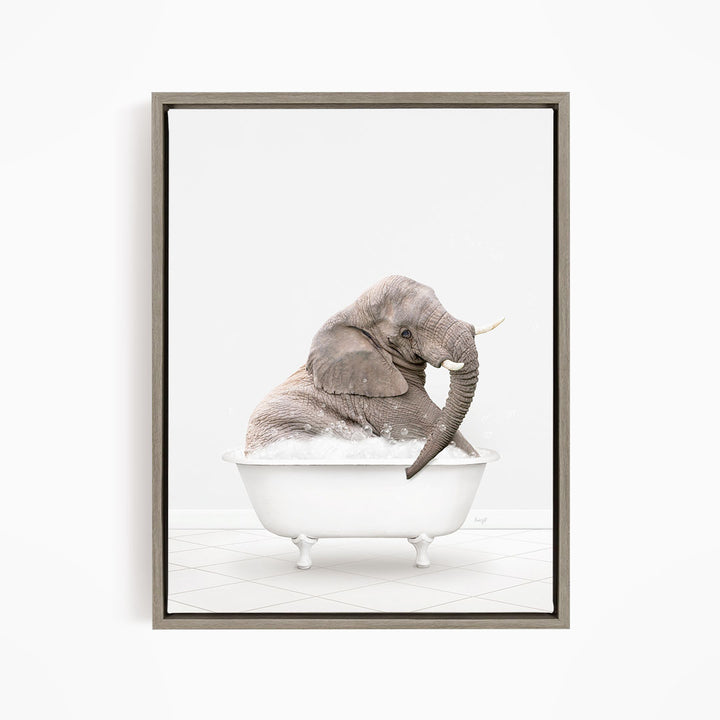 A gray elephant sitting in a white bathtub filled with bubbles, with its trunk raised in the air.