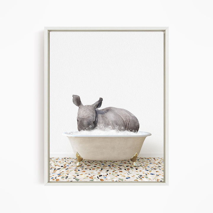 A rhinoceros is sitting in a bathtub filled with water, creating a whimsical and playful scene.