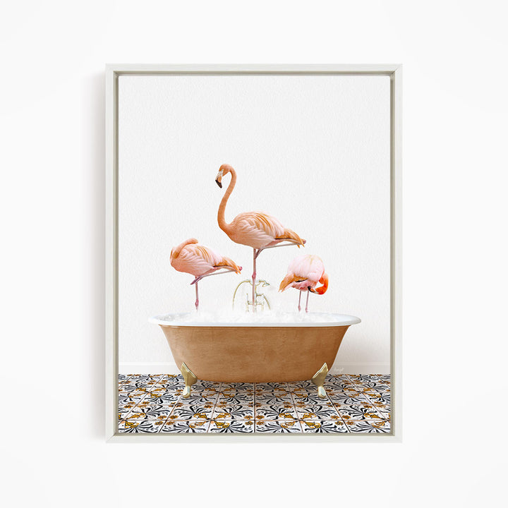 A framed image depicting three pink flamingos standing in a bathtub filled with water, with a patterned tile floor beneath.