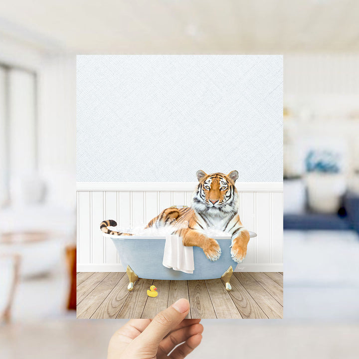 A tiger is sitting in a bathtub filled with water, surrounded by a white towel and a rubber duck.