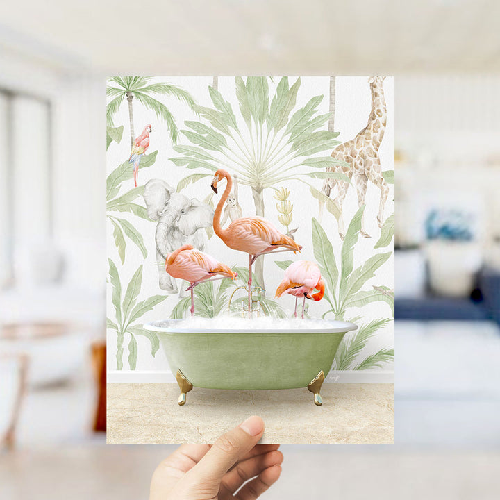 A hand holds up a framed print featuring a vibrant illustration of a green bathtub filled with water, surrounded by various tropical animals such as flamingos, elephants, and a giraffe.