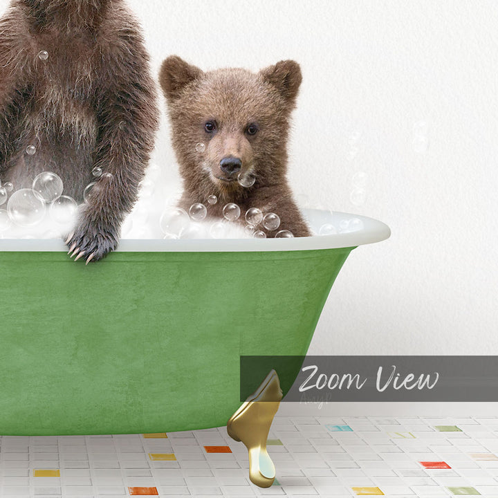 A young bear cub sitting in a green bathtub filled with bubbles, with a text overlay that reads "Zoom View".