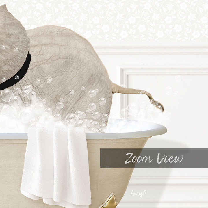 A white elephant is sitting in a bathtub filled with bubbles, with a towel hanging on the side.