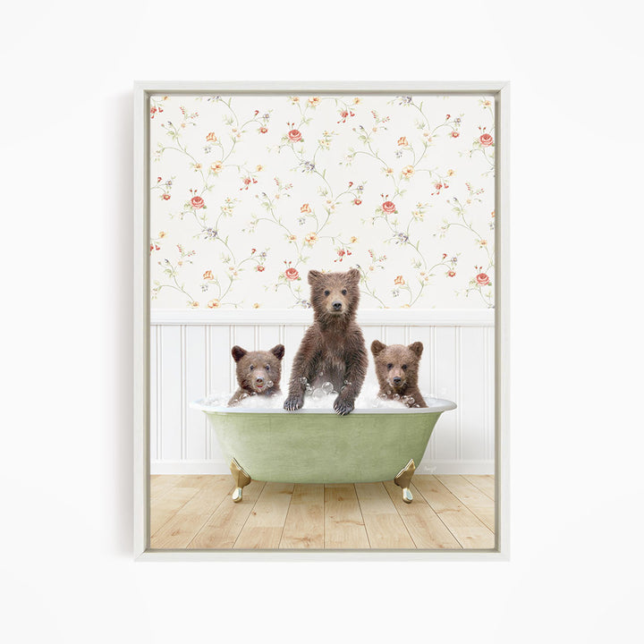 A framed image depicting three bears sitting in a green bathtub, with a floral wallpaper in the background.
