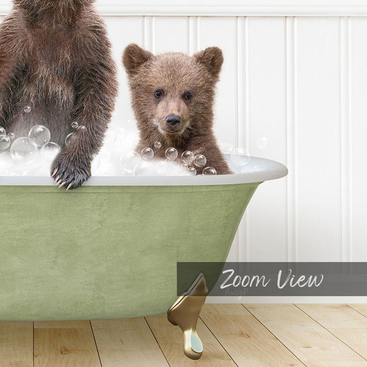 A young bear cub sitting in a green bathtub filled with bubbles, with a text overlay that reads "Zoom View".